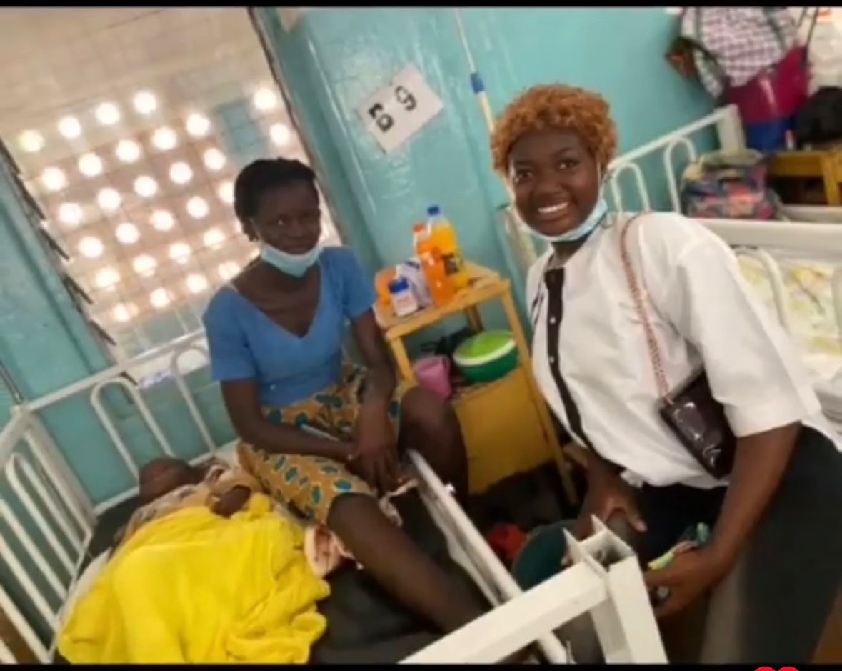 Volunteer visiting a mother and child at their hospital bedside