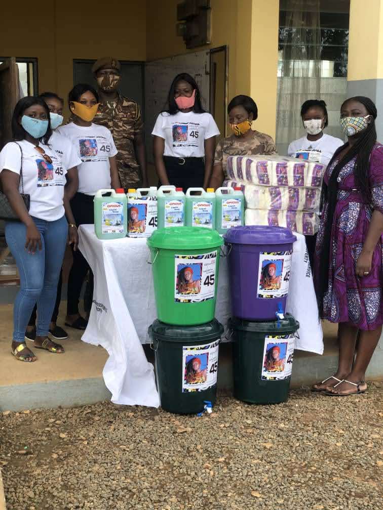 Team presenting donated sanitation supplies, soap and blankets