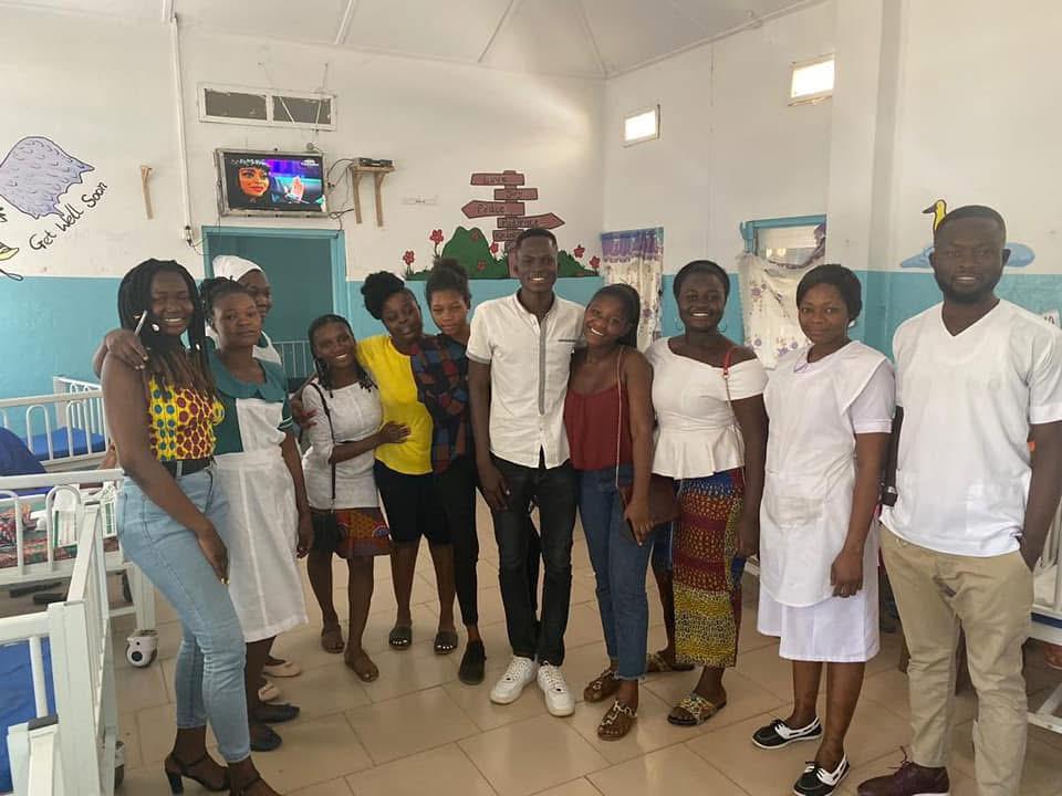 Volunteers standing with hospital nurses after a ward visit