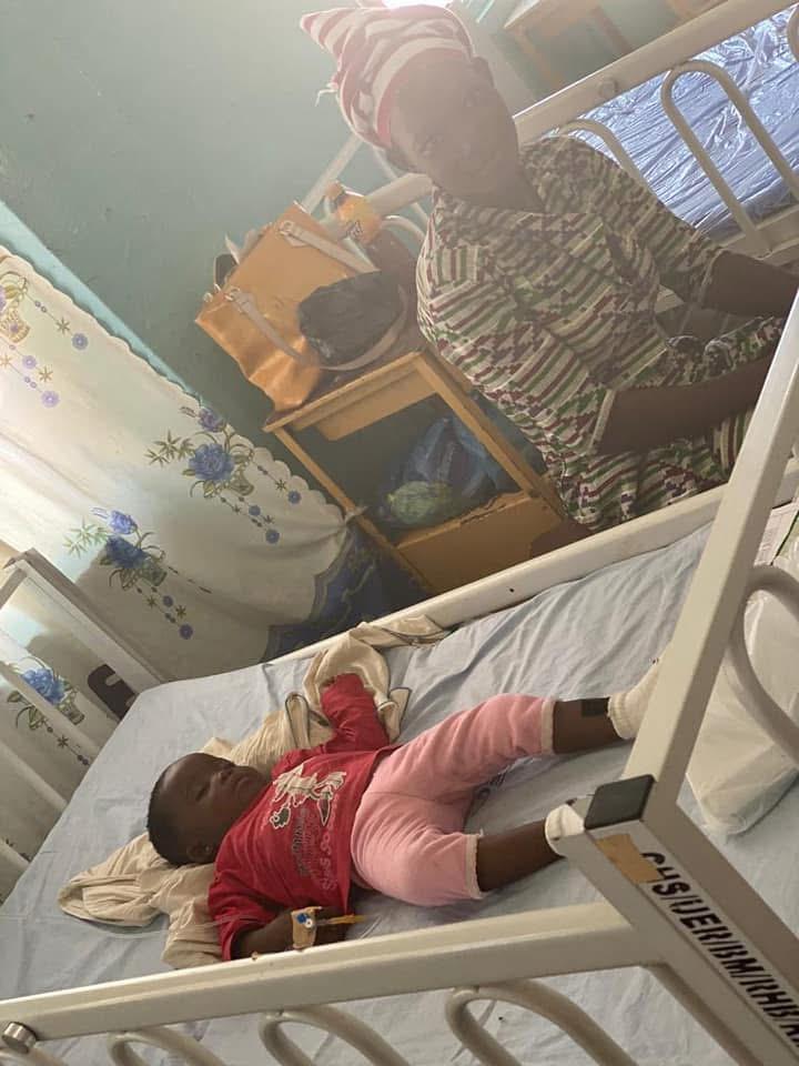 Mother beside her baby resting in a hospital cot