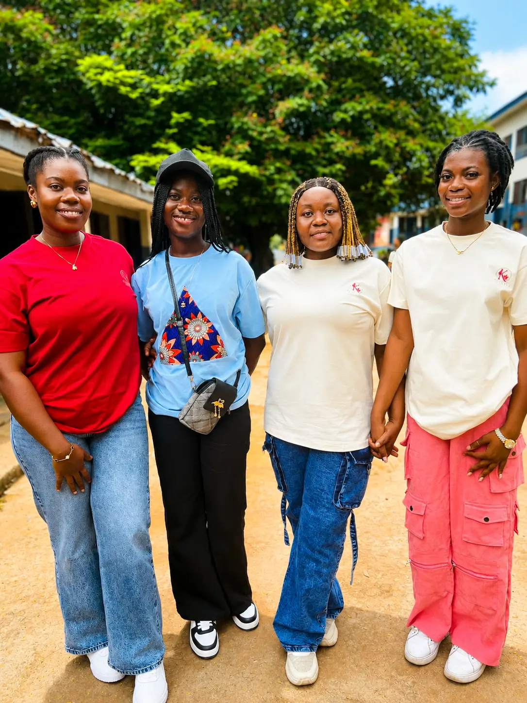 Four Kelsies Foundation volunteers standing together at the school