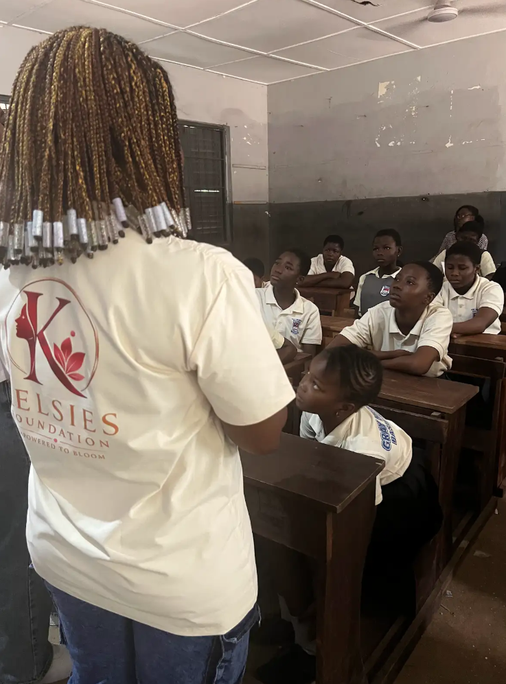 A Kelsies Foundation volunteer speaking with students in a classroom